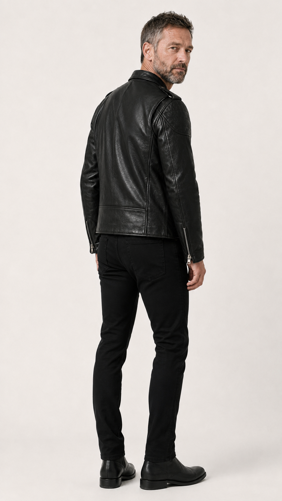 Back view of a man wearing the black perfecto leather jacket — British model