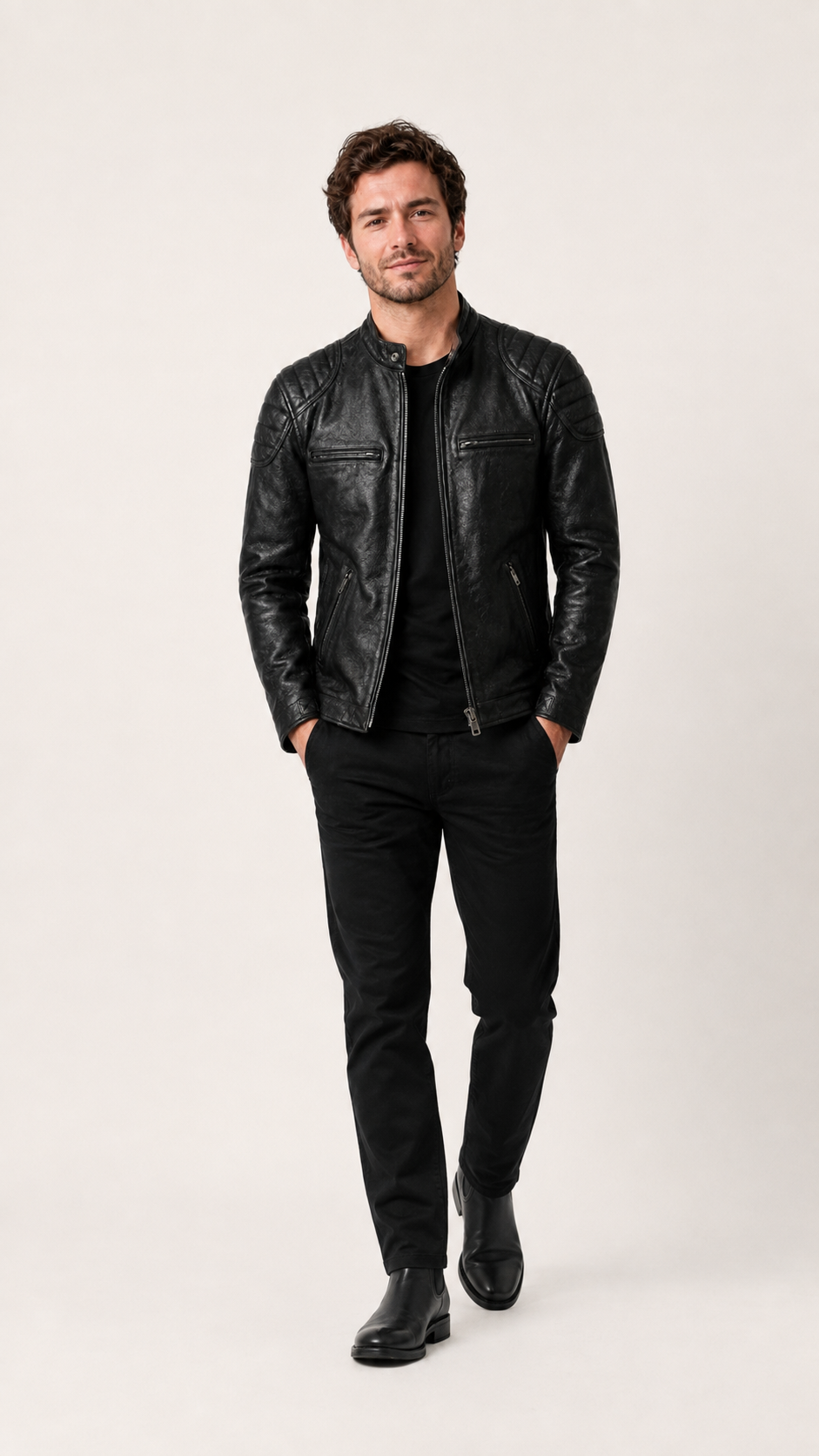 Man walking in the black vintage leather biker jacket, hands in pockets — British model