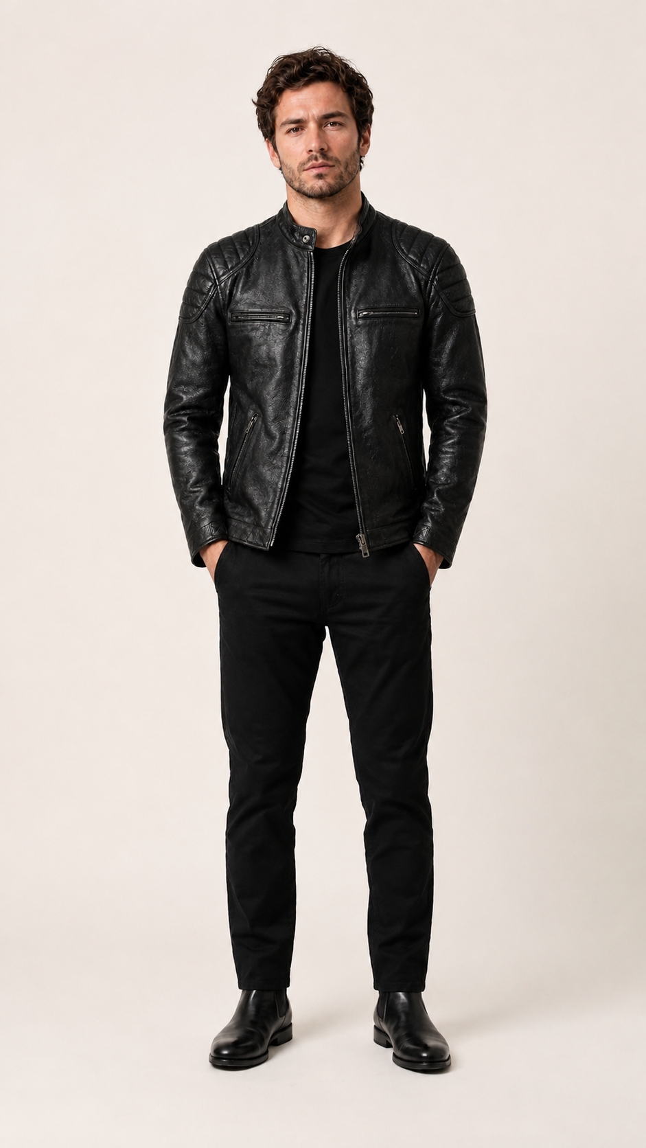 Full-length front view of the black leather biker jacket worn with black trousers — British model
