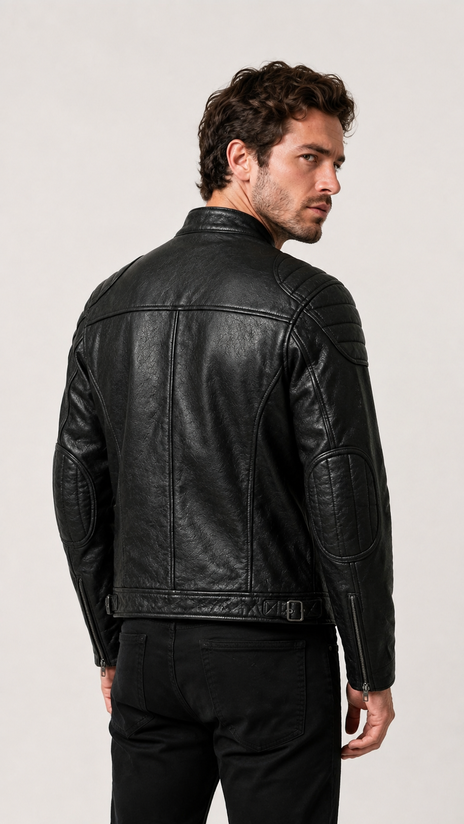 Back view of a man wearing the black vintage leather biker jacket — British model