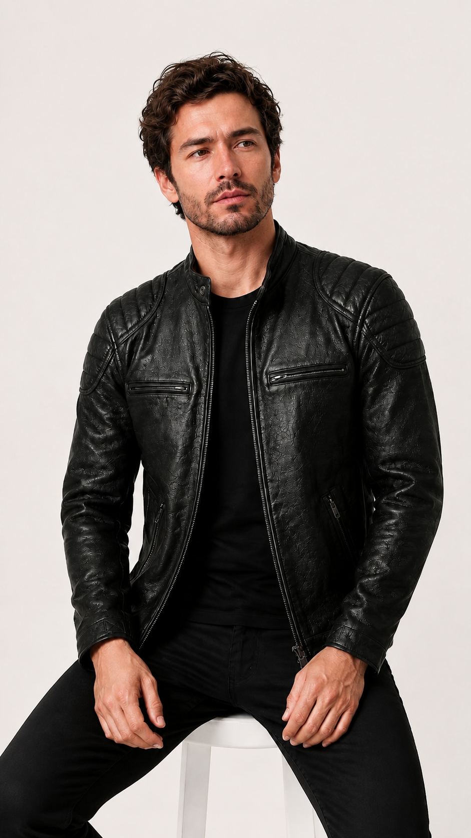 Man seated in the black leather biker jacket — British model